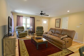 Living room with electric fireplace and 50 inch TV. 
