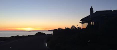 This silhouette view of the home reveals the inspiring window views at dusk.