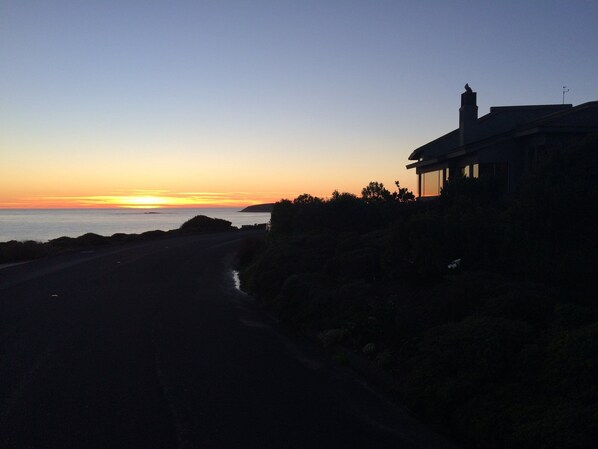 This silhouette view of the home reveals the inspiring window views at dusk.