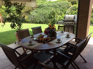 portico with table and 8 chairs
