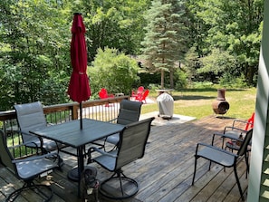 Ample seating with deck overlooking the river and roomy fire pit area.