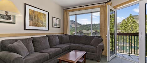 Living room with fireplace and expansive views.