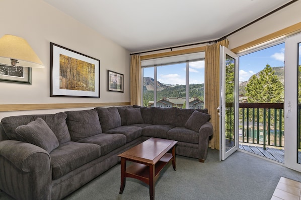 Living room with fireplace and expansive views.