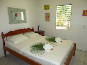 Bright bedroom with garden view and shutters to keep it dark for sleeping wel