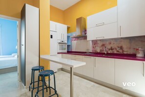 Modern kitchen with utensils for cooking and main appliances.