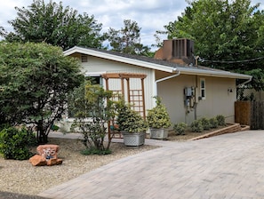 Front of home with private paver driveway and path to front door.