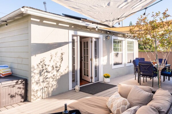 This is San Diego beach living! This amazing patio with comfy couch, dining for six, and hot tub is just outside!