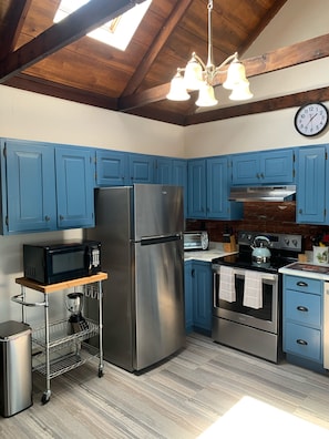 Kitchen has electric stove and fully applianced.