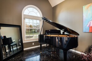 Music room with beautiful player grand piano.