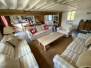 Living area with 3 triple sofas and armchair