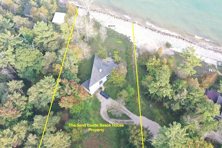 The private, beautiful 2 acre lakeside lot is surrounded by forest.