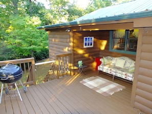Private back deck with charcoal grill.