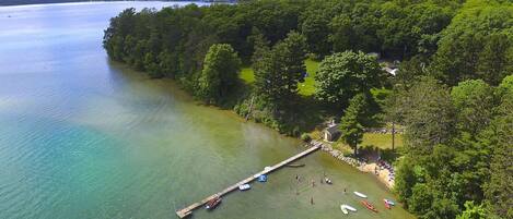 32 acres with 5 acres of flat lawn, a sandy beach and caribbean-like water.