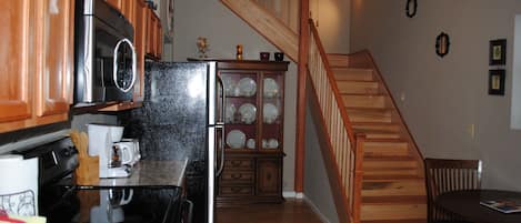 Kitchen and stairs leading to second floor with two bedrooms and one bathroom