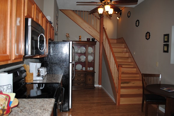 Kitchen and stairs leading to second floor with two bedrooms and one bathroom