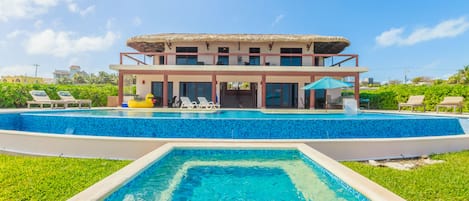 Back yard view of the dipping pool, main pool and back of the Casa