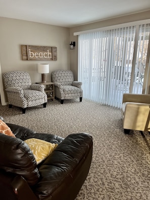 Living room with sliding glass doors. Views of lake. 