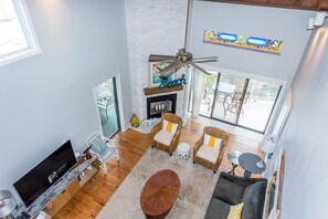 Huge vaulted ceilings with exposed wood beams give it a beach bungalow feel