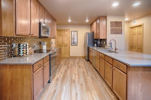 Newly updated kitchen featuring quartz counters & stainless steel appliances! 