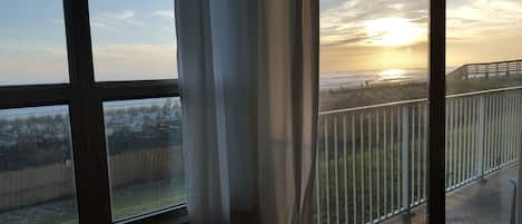 Master Bedroom View At Sunset with Sliding Glass Door to Patio