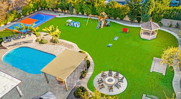 [Resort Property] Backyard amenities with heated pool, basketball court, playground, grill and firepit areas