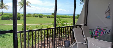 View of Gulf of Mexico from the lanai with beach chairs/umbrella and sand toys