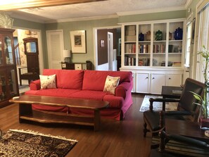 Living / TV Room with view to Foyer, Half Bath, and Breakfast Room.
