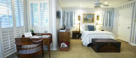 View upon entrance into your spacious, luxurious suite replete with Tempurpedic bed, fine art,  windows with shutters and an antique writing desk! 