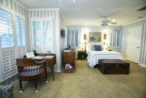 View upon entrance into your spacious, luxurious suite replete with Tempurpedic bed, fine art,  windows with shutters and an antique writing desk! 
