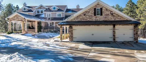 Front with portico and round driveway, 4 car and plenty of additional parking.