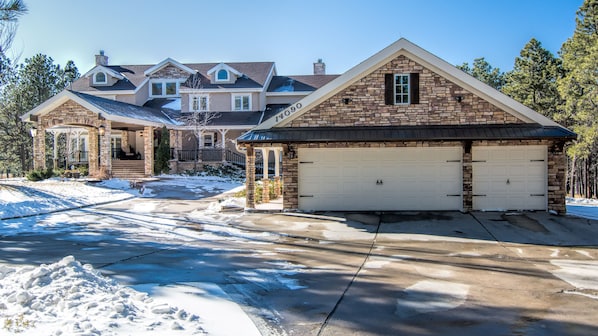 Front with portico and round driveway, 4 car and plenty of additional parking.