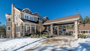 View: side of house:  Trees on both sides of portico flower in spring and summer