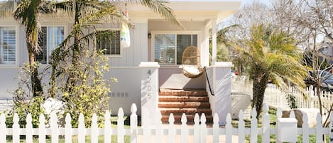 Front of home with swinging chair to enjoy your coffee!