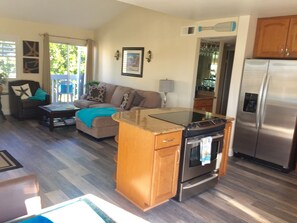 Kitchen and Living room with new HD smart flat screen TV and two sliding doors.