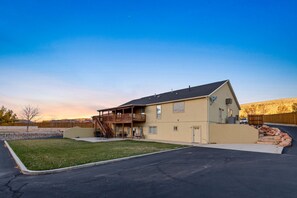 Back lawn, covered patio/deck with summer shades. Ample parking!  
