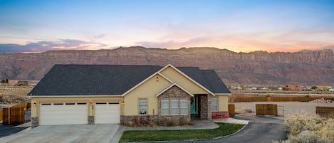 Front View of home and the Moab Rim in the evening. Displays ample parking  also