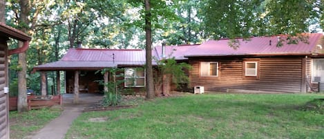 The Cabin in the Cove nestled amongst majestic towering oaks in the Ozarks