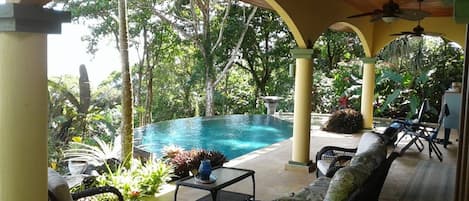 Covered veranda by infinity pool