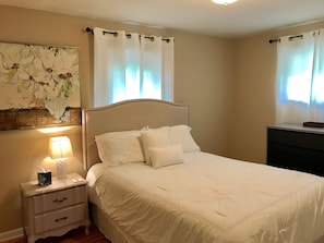 Main level bedroom with queen bed