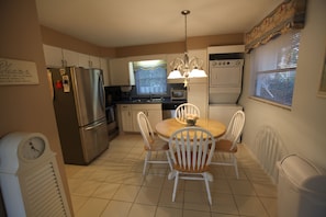 Kitchen has stainless steel appliances, dishwasher, and washer and dryer.