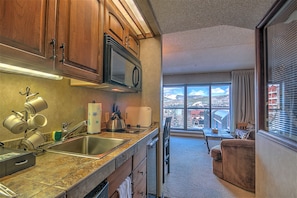 Kitchenette with stovetop and microwave. New faucet installed .