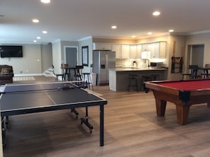 Game room with kitchen, pool table, ping pong, and two 70 inch Televisions !