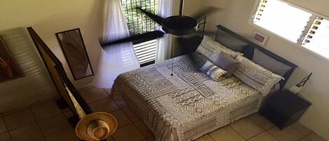 Sleeping area as seen from the loft. Windows and ceiling fans for ventilation