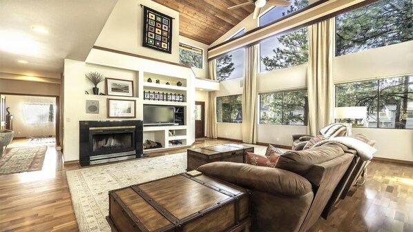 Great room with fireplace, Smart TV, and access to decks.