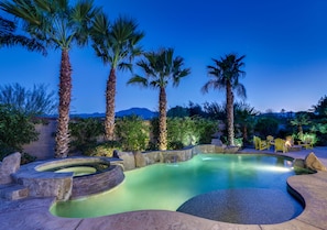 Large pool with tanning shelf and calming waterfalls