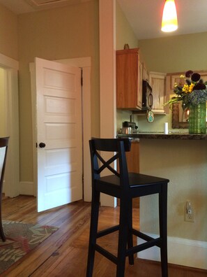 Dining and kitchen from living area. 4-5 can sit around the counter.