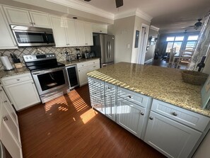 Kitchen with stainless appliances and bar fridge