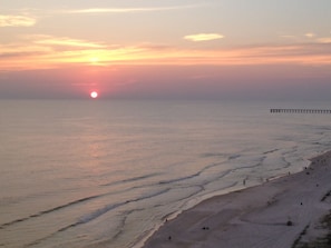 Another beautiful day ends at beach, county pier in distance.