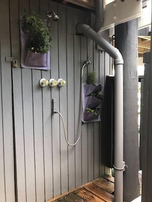 External shower for sand removal after beach day.