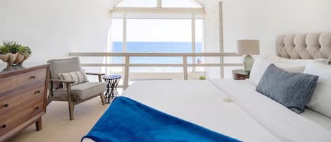 Primary bedroom has an oceanfront view, vaulted ceiling and en-suite bathroom